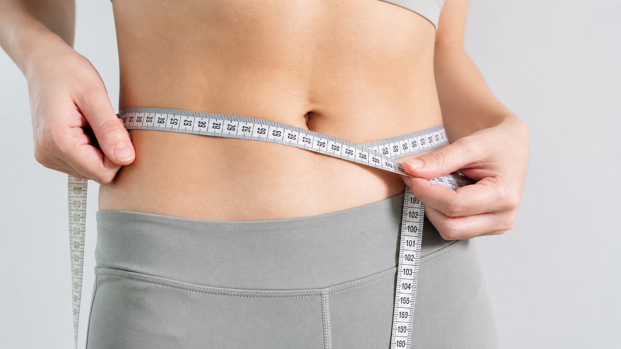 Measuring tape around a waist representing body fat distribution measurement