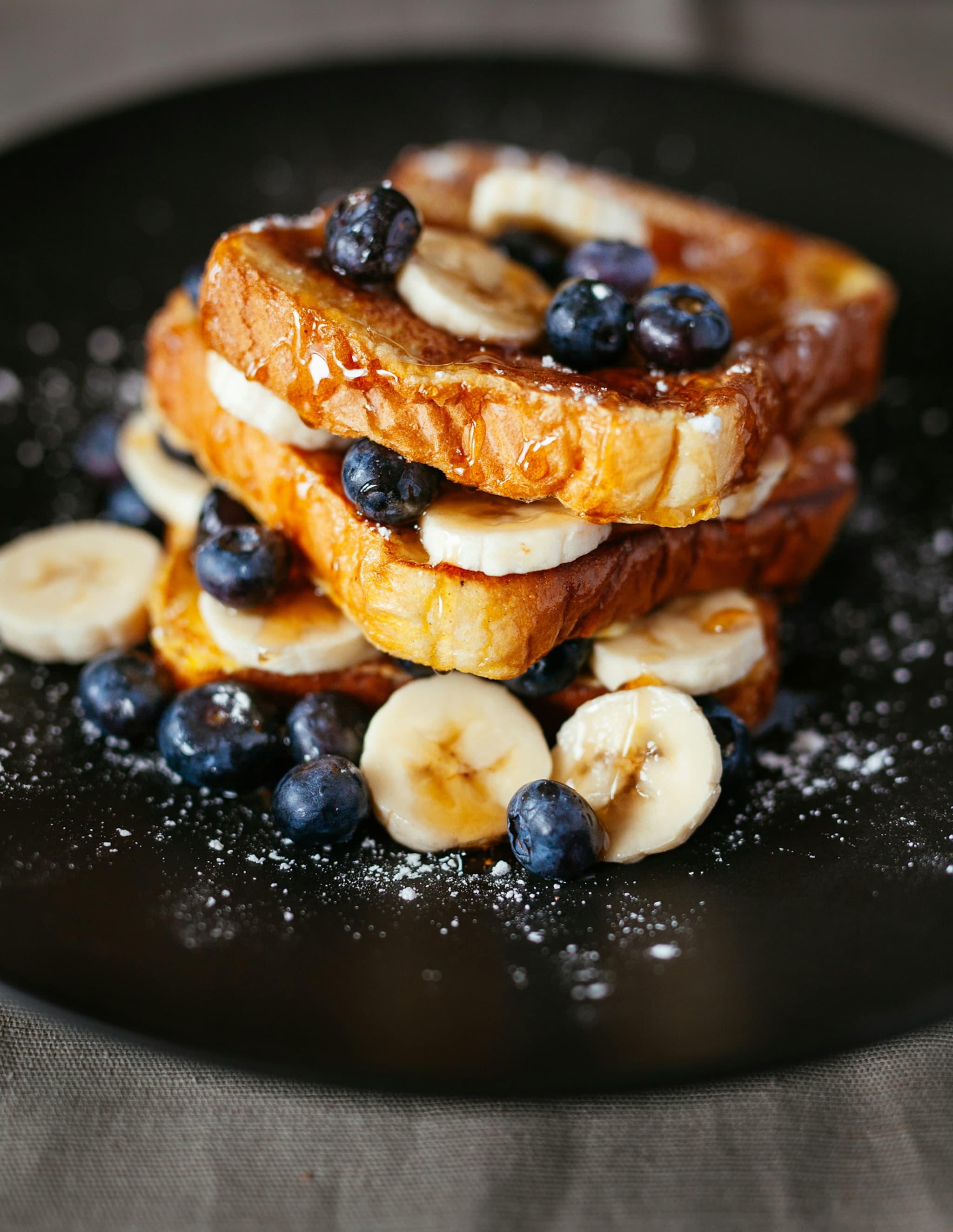 A well structured breakfast plate photographed from above with a generous protein source, complex carbohydrates, and colourful fruit