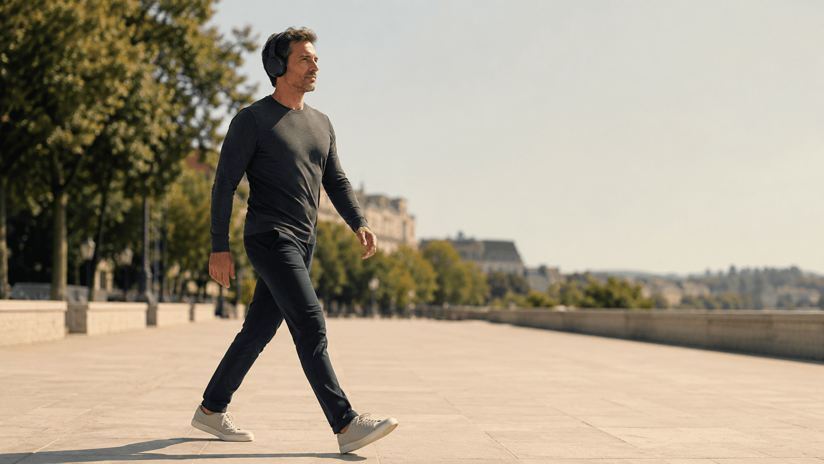 A person briskly walking outdoors at a sustainable pace, capturing the role of LISS as the everyday foundation of cardio — the form that lifts daily NEAT, supports recovery, lowers cortisol and improves sleep without interfering with resistance training