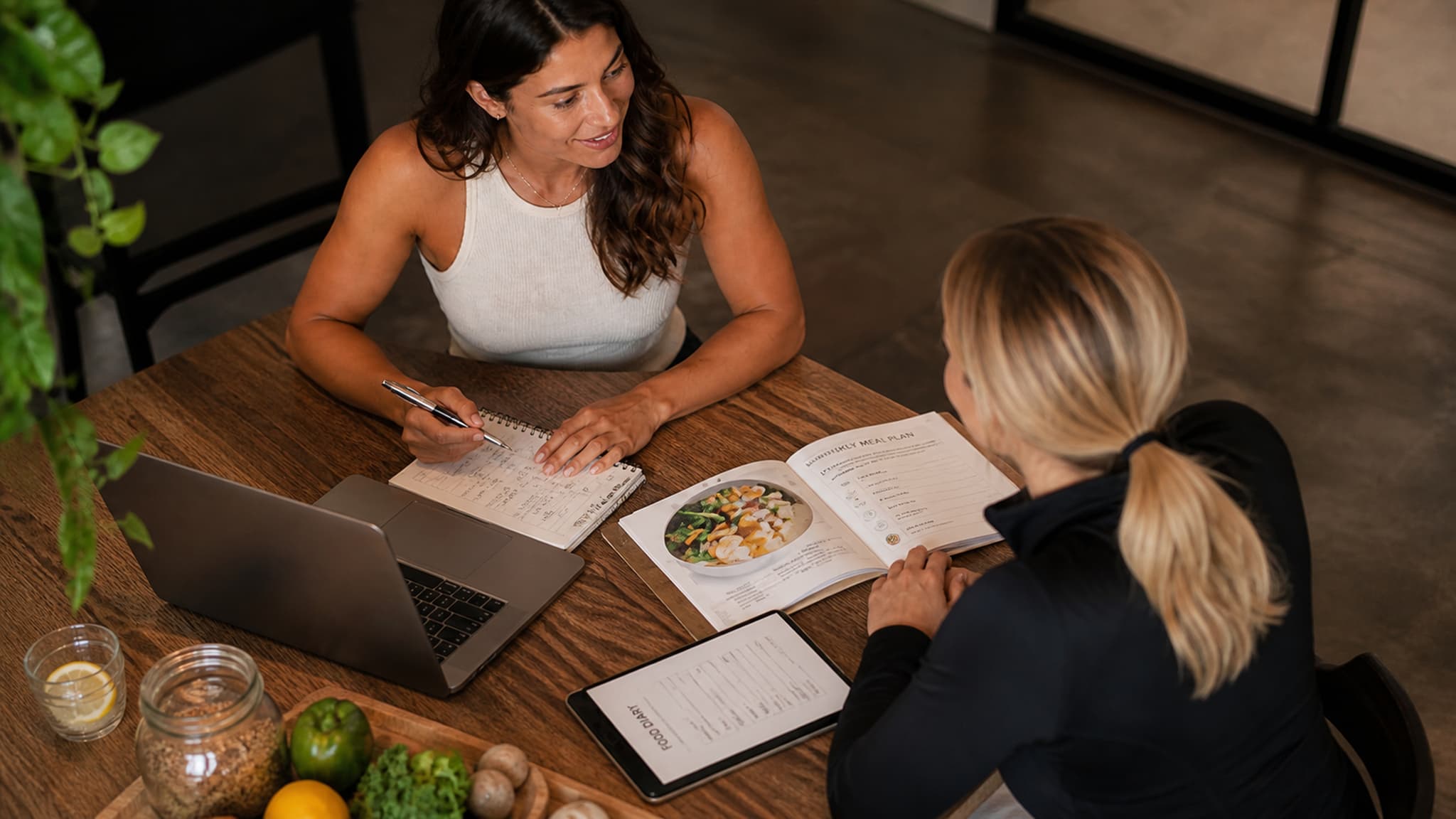 A coach and client in a personalised nutrition consultation, adapting the plan to the individual's health conditions, preferences, and lifestyle