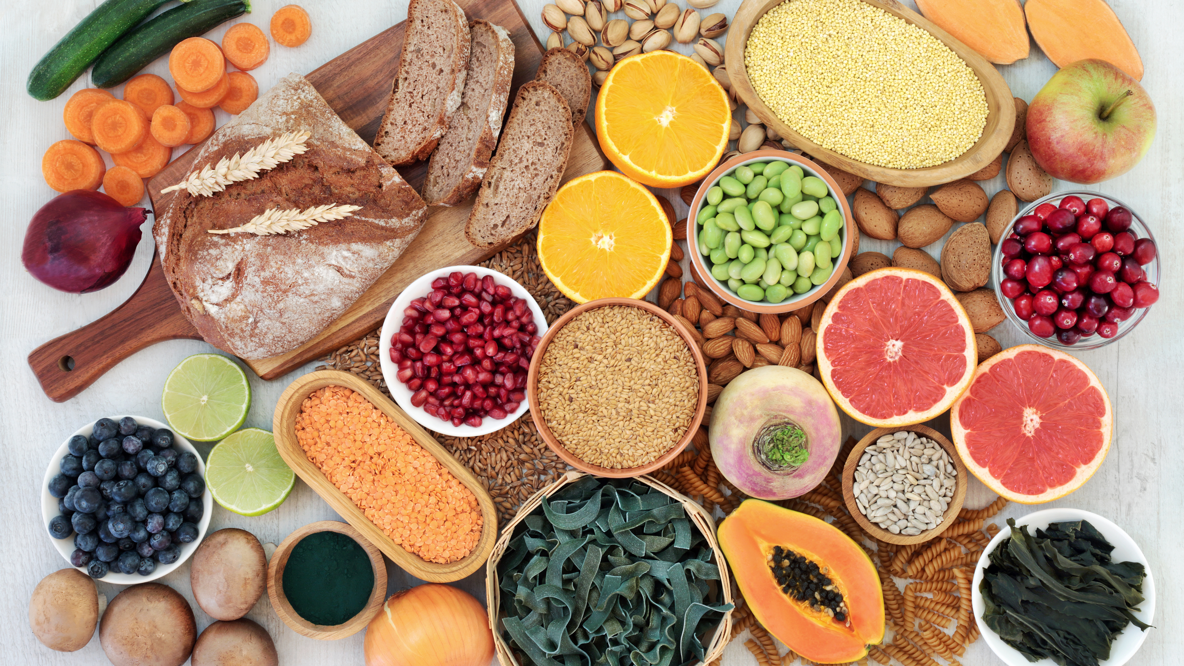 High-fibre foods including lentils, chickpeas, and various beans arranged on a surface