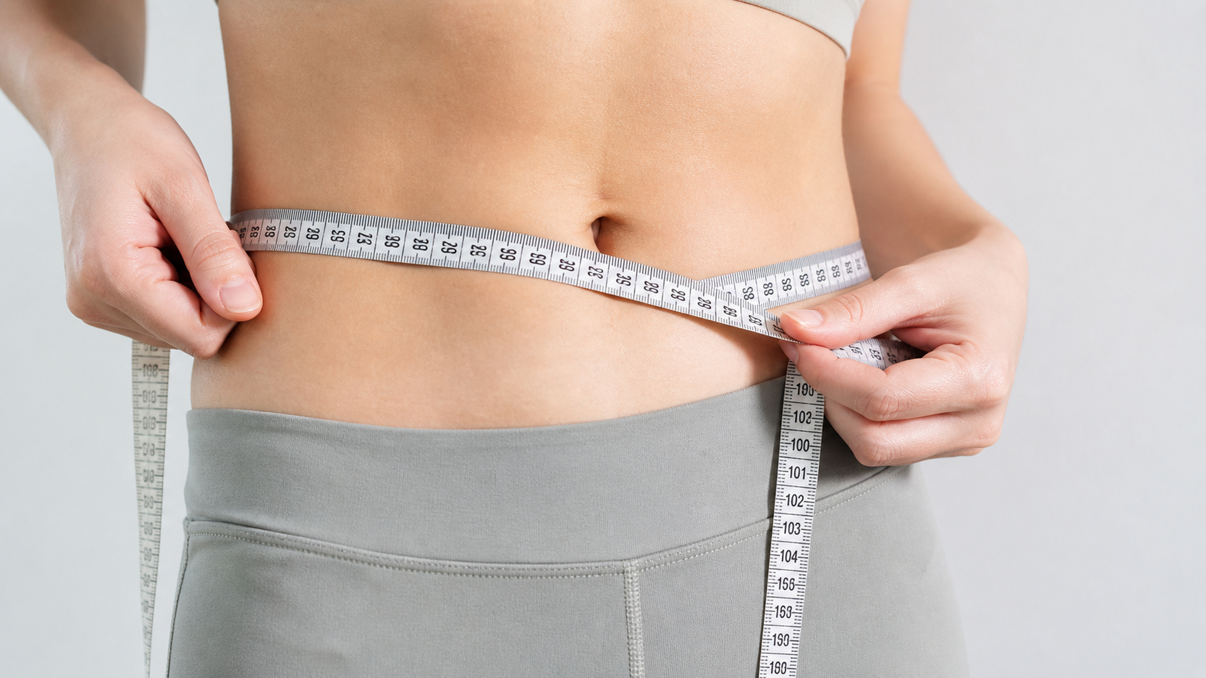 Measuring tape around a waist representing body fat distribution measurement