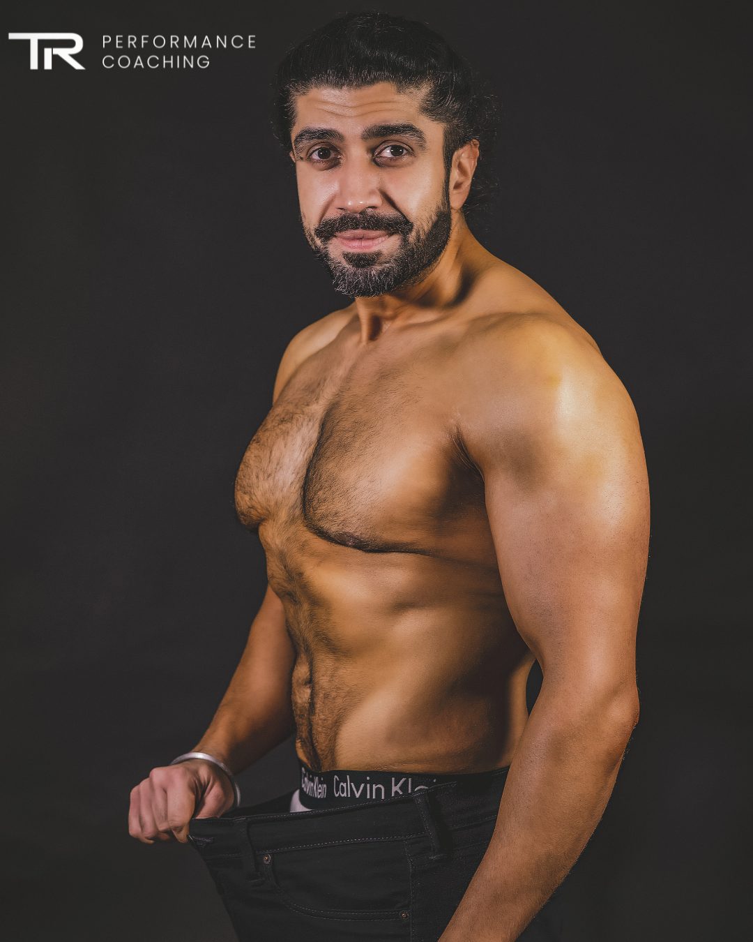 Dr Ajit Singh Hunjan holding out his old trousers